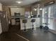 Bright kitchen featuring counter seating, stainless steel appliances, and black tile flooring at 3381 Walkers Ridge Rd, Dacula, GA 30019