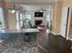 Open floor plan showcasing the kitchen with granite countertops and view into the living room at 3381 Walkers Ridge Rd, Dacula, GA 30019