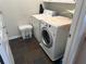 Functional laundry area with tile flooring, washer, dryer, and storage at 3381 Walkers Ridge Rd, Dacula, GA 30019
