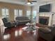 Comfortable living room featuring hardwood floors, a fireplace, and plush leather seating at 3381 Walkers Ridge Rd, Dacula, GA 30019