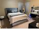 Luxurious main bedroom with a tufted headboard bed and a vanity desk at 3381 Walkers Ridge Rd, Dacula, GA 30019