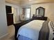 This comfortable main bedroom features a dark wood dresser and plenty of natural light at 3381 Walkers Ridge Rd, Dacula, GA 30019