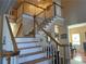 Beautiful staircase with white risers and wooden banister at 3381 Walkers Ridge Rd, Dacula, GA 30019
