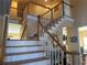 Elegant staircase with wood banister and white risers at 3381 Walkers Ridge Rd, Dacula, GA 30019