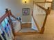 Carpeted stairway with white and natural wood banister leading to the first floor at 3381 Walkers Ridge Rd, Dacula, GA 30019
