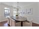 Bright dining room with large windows, modern chandelier, and seating for eight at 4233 Hardy Ave, Smyrna, GA 30082