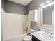 Bathroom with a shower-tub combination, white vanity, marble countertop, and a decorative mirror at 6498 Stonelake Sw Pl, Atlanta, GA 30331