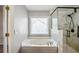 Bathroom featuring a tub and glass enclosed shower at 6498 Stonelake Sw Pl, Atlanta, GA 30331