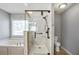 Bathroom features glass enclosed shower and tub with window at 6498 Stonelake Sw Pl, Atlanta, GA 30331