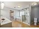 Bright bathroom featuring a glass shower, tub, and double vanity, creating a spa-like retreat at 6498 Stonelake Sw Pl, Atlanta, GA 30331