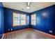 Bedroom featuring blue walls, two windows, and hardwood floors at 6498 Stonelake Sw Pl, Atlanta, GA 30331