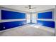 Bedroom with a ceiling fan, carpeted floors, blue accent walls, and white crown molding at 6498 Stonelake Sw Pl, Atlanta, GA 30331