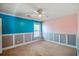 Bedroom featuring a ceiling fan, carpeted floors, and teal and pink painted walls at 6498 Stonelake Sw Pl, Atlanta, GA 30331