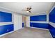 Bedroom featuring a ceiling fan, carpeted floors, blue accent walls, and white trim at 6498 Stonelake Sw Pl, Atlanta, GA 30331