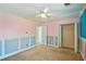 Bedroom with a ceiling fan, pink walls, light-blue trim, and a closet at 6498 Stonelake Sw Pl, Atlanta, GA 30331