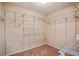 Walk-in closet with multiple shelves and hanging rods for clothing storage at 6498 Stonelake Sw Pl, Atlanta, GA 30331