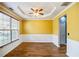 Dining room showcasing a tray ceiling, wainscoting, and ample natural light from a large window at 6498 Stonelake Sw Pl, Atlanta, GA 30331