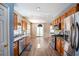 Modern kitchen with stainless steel appliances, wood cabinets, and access to dining area at 6498 Stonelake Sw Pl, Atlanta, GA 30331