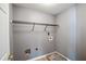 Small laundry room with gray walls, open shelving and utility hookups at 6498 Stonelake Sw Pl, Atlanta, GA 30331