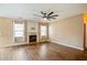 Open living room features a fireplace, fan, and large windows with custom blinds at 6498 Stonelake Sw Pl, Atlanta, GA 30331