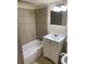 Bathroom featuring tile shower, modern vanity, and updated fixtures at 6950 Oakhill Se Cir, Austell, GA 30168
