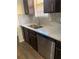 Kitchen featuring stone countertops, mosaic backsplash, stainless steel appliances, and dark wood cabinets at 6950 Oakhill Se Cir, Austell, GA 30168
