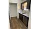 Kitchen featuring stone countertops, mosaic backsplash, stainless steel appliances, and dark wood cabinets at 6950 Oakhill Se Cir, Austell, GA 30168