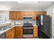 A well-lit kitchen featuring granite countertops, stainless steel appliances, and wood cabinets at 8030 S Bay Ct, Riverdale, GA 30274