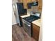 Close-up of kitchen with stainless steel appliances and wood cabinets at 2303 Pine Tree Trl, Atlanta, GA 30349
