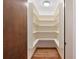 Walk-in pantry featuring white shelving and wood flooring providing ample storage space at 3897 Allsborough Dr, Tucker, GA 30084