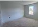 Unfinished bedroom with bare walls and flooring showcasing a bright window at 691 Calvet Way, Cumming, GA 30041