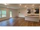 Open concept living room with hardwood floors and lots of natural light at 691 Calvet Way, Cumming, GA 30041