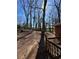 Backyard featuring mature trees, a wood fence and a brick home at 1686 Valencia Rd, Decatur, GA 30032