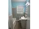 Bathroom featuring tub with shower, sink, toilet and shelving at 1686 Valencia Rd, Decatur, GA 30032