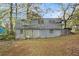 View of the back of the home showcasing the yard, two stories, and basement entrance at 2057 Akron Se Dr, Atlanta, GA 30315