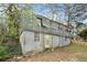 View of the rear of the two-story home with a basement, visible windows, and siding at 2057 Akron Se Dr, Atlanta, GA 30315