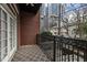 Outdoor balcony with black iron railings, exposed brick, and a view of the surrounding neighborhood at 850 Piedmont Ave # 2102, Atlanta, GA 30308