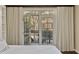 Bedroom with neutral tones, hardwood floors, and large windows with access to a balcony at 850 Piedmont Ave # 2102, Atlanta, GA 30308