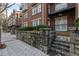 Brick exterior with a stone retaining wall, balcony, and wrought iron railing at 850 Piedmont Ave # 2102, Atlanta, GA 30308