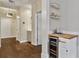 Hallway with hardwood floors leads to a built-in bar area with a wine fridge and floating shelves at 850 Piedmont Ave # 2102, Atlanta, GA 30308