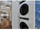 Stackable washer and dryer unit next to a kitchen with stainless steel appliances at 850 Piedmont Ave # 2102, Atlanta, GA 30308