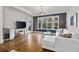 Spacious living room boasts hardwood floors, large windows, and modern decor at 850 Piedmont Ave # 2102, Atlanta, GA 30308