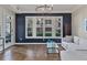 Bright living room featuring a large window, hardwood floors, and a stylish navy accent wall at 850 Piedmont Ave # 2102, Atlanta, GA 30308