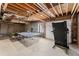 Unfinished basement featuring concrete floors and walls, open ceiling, and garage door access at 1410 Barnsley Walk, Snellville, GA 30078