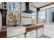 Cozy kitchen featuring farm sink, stainless steel vent hood, and butcher block countertop at 1410 Barnsley Walk, Snellville, GA 30078