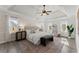 Spacious main bedroom featuring a tray ceiling, brick wall and ample natural light at 1410 Barnsley Walk, Snellville, GA 30078