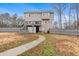 Exterior view of home's fenced backyard with deck, green grass, and wooded backdrop at 194 Preston Nw Pl, Dallas, GA 30157