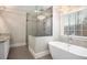 Beautiful bathroom features a glass shower, soaking tub, and lovely chandelier at 194 Preston Nw Pl, Dallas, GA 30157