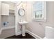 Charming bathroom featuring a pedestal sink and bright window with natural light at 194 Preston Nw Pl, Dallas, GA 30157