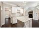 White kitchen with a kitchen island and stainless appliances is open and bright at 194 Preston Nw Pl, Dallas, GA 30157